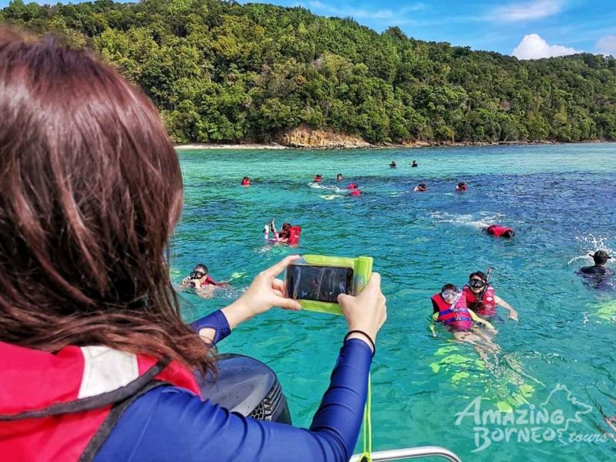 A woman taking a picture of the water