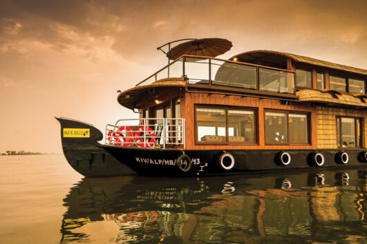 A boat floating on top of water near the shore.