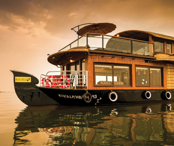 A boat floating on top of water near the shore.
